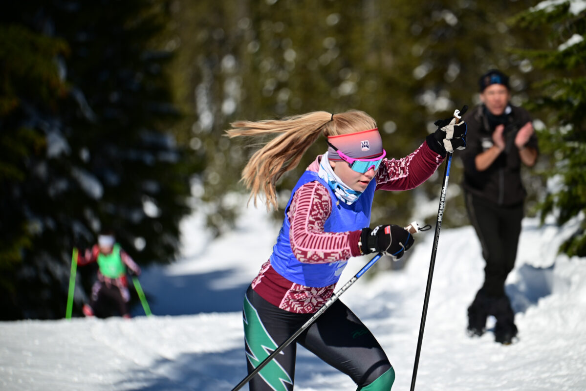 Summit girl Skier being cheered by coach Northern